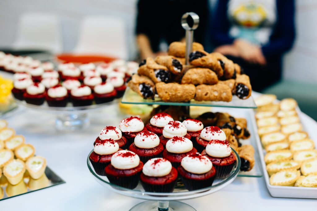 Plate with cakes and desserts. Red velvet cake and canoli. Festive food